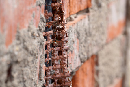 Broken brick wall with a hole in it. Selective focus.の写真素材