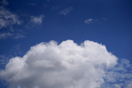 Blue sky background with white clouds. Cumulus white clouds in the blue sky.の写真素材