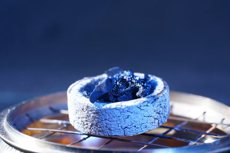 Close-up of blue coal briquettes on a blue backgroundの写真素材