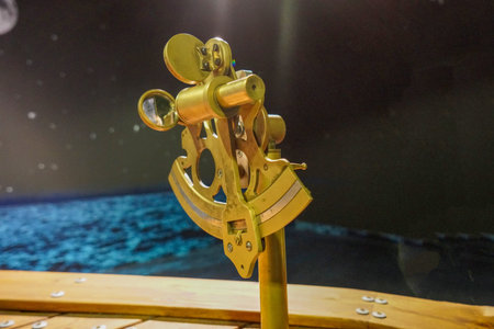 Vintage brass telescope on a wooden table in a marine aquarium.の写真素材