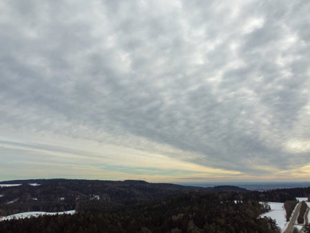 snowy agricultural snowy fields in bavaria on a cloudy dayの写真素材