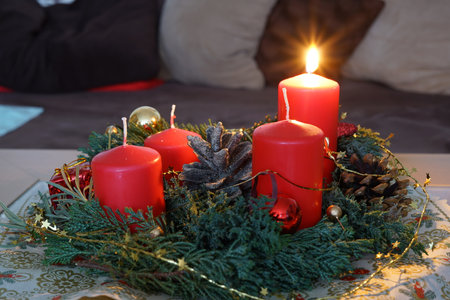 Christmas with red candles and christmas tree balls and green fir branches and pine conesの写真素材