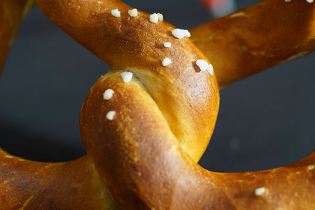 Pretzel served fresh with salt and butter in detailの写真素材