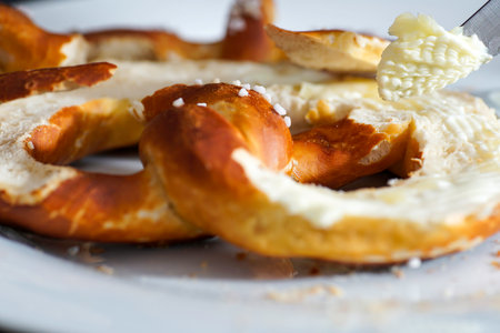 Bavarian pretzels with butter on a white plate.の写真素材