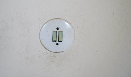 Old light switches in a lost place in a forgotten timeの写真素材