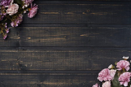 Pink flowers on wooden boards in the corners. Beautiful flowers. Wooden background