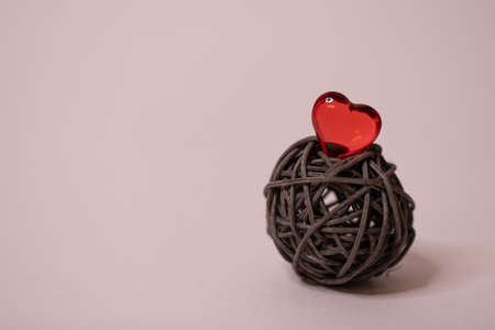 Colorful heart on a brown tangle, isolated on a white background. Space for the text. Red heart as a symbol of love. Concept of hobby, palpitations,feelings, romance.の写真素材