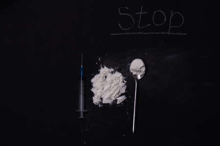 Heroin and drug paraphernalia are placed on a black background. The concept of crime and drug addiction. International Day against Drug Abuse and Illicit Traffickingの写真素材