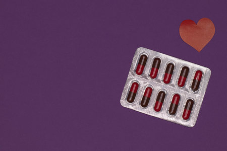 Packaging of capsules, tablets on a purple background to protect and protect the health of patients...