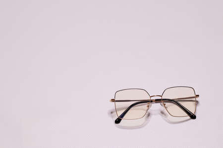 Stylish glasses on a white background. Optical store, selection of glasses, eye test, vision check at the optician, the concept of fashion accessories. Top view, Flat lay. High quality photoの写真素材