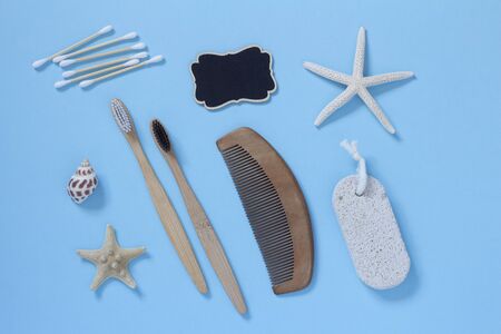 Eco living concept. Bamboo toothbrushes, wooden hairbrush, wooden ear sticks on a blue background top view. Zero plastic conceptの写真素材