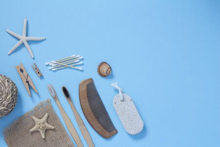 Eco living concept. Bamboo toothbrushes, wooden hairbrush, wooden ear sticks on a blue background top view. Zero plastic conceptの写真素材