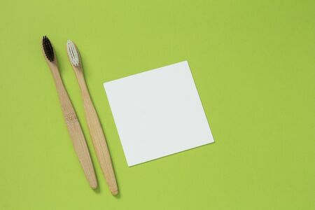 Eco living concept. Bamboo toothbrushes on a green background top viewの写真素材