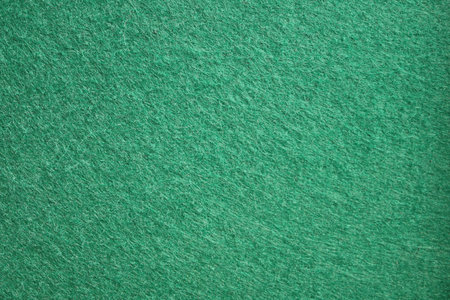 A detailed close-up texture of a green felt fabric surface commonly used for billiard or poker tables. Concept: Concept of textile background.の写真素材