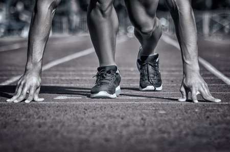 Sport. Unrecognizable runner on the starting -- selective focus, toned and stylized photo