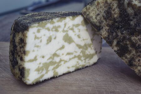 Craft cheese from cows and goats milk. Cheese head. Selective focusの写真素材