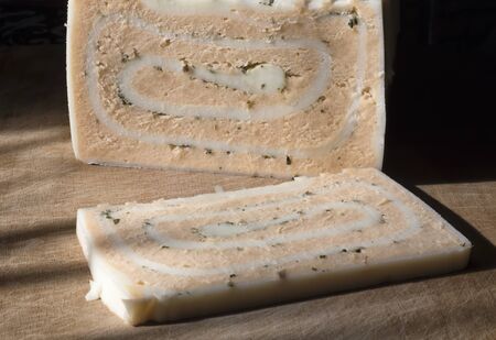 Craft cheese from cows and goats milk. Cheese head. Selective focusの写真素材
