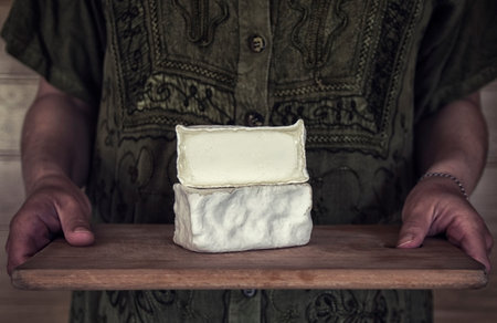 Craft cheese from cows and goats milk. Cheese head. Crottin