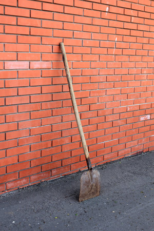 The shovel standing against red brick wallの写真素材
