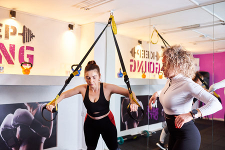 women on training in the gym. sports activities, exercise under the guidance of a trainer