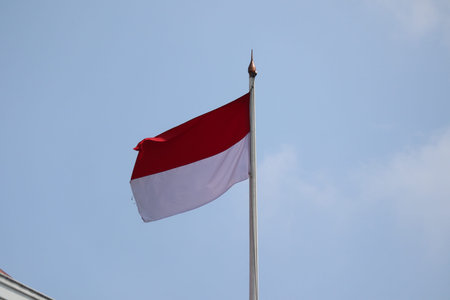 Indonesia flag on a blue sky background. National flag of Indonesiaの写真素材