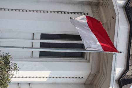 Indonesian flag on a pole in the city of Jakarta, Indonesiaの写真素材