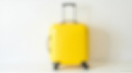 Vibrant yellow suitcase ready for exciting travel adventures, bright and modern design.の素材