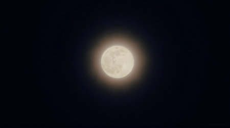 Stunning full moon glowing brightly in the dark night sky offering a sense of wonder and lunar magicの素材