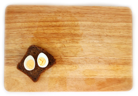 Boiled Quail eggs and wholegrain bread on wooden board flat lay with space for sign, healthy food...