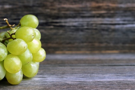 Fresh grape on dark wooden background with copy spaceの写真素材