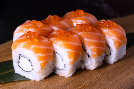 philadelphia sushi with red caviar on a wooden boardの写真素材