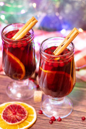 two glasses of mulled wine, a garland in the background. Winter New Years drinkの写真素材