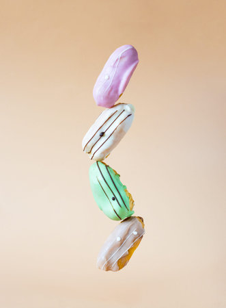 balancing multicolored eclair cakes