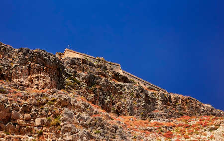 GRAMVOUSA - BALOS, THE CRETE ISLAND, GREECE - JUNE 4, 2019: View on the pirate castle on the top of the mountain on the Gramvousa island.のeditorial素材