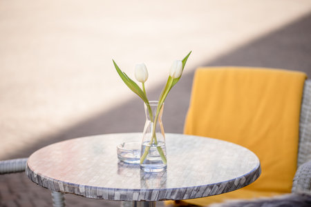 Empty tables outside between lunch hours along a cobblestone alley in a European city, a veranda, a cafeの写真素材