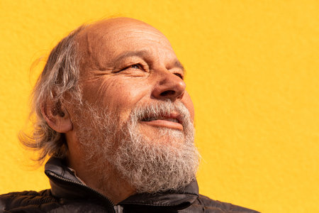 Portrait of a confident, handsome, mature man, pensioner, grandfather in the small townの写真素材