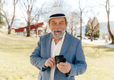 Portrait of a confident, handsome, mature man, pensioner, grandfather in the small town
