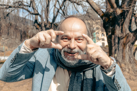 Portrait of a confident, handsome, mature man, pensioner, grandfather in the small town