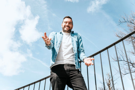 Portrait of a handsome hipster man in a jean jacket. A man in a big city on the street, a life style...