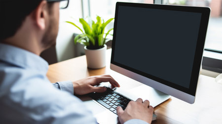 Hands of a man sitting at his laptop in the office at work, Generated AIの素材
