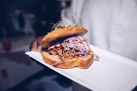 Pulled pork sandwich with coleslaw on a sesame bun