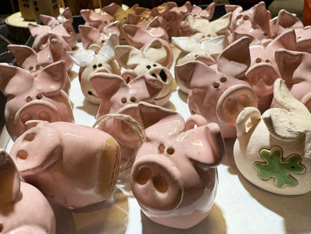 Collection of pink ceramic pig figurines on display.の写真素材