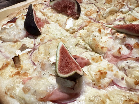 Gourmet fig and prosciutto pizza with creamy mozzarella and red onions.の写真素材