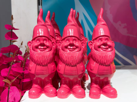 Pink garden gnomes in vibrant display at florist shop.の写真素材