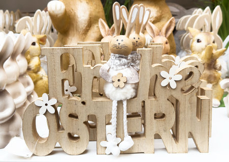 Wooden easter bunny decor with flowers and playful design.の写真素材