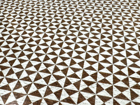 Brown and white geometric triangle pattern wooden surface texture.の写真素材