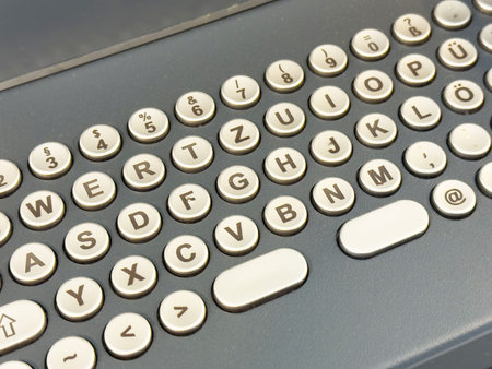 Retro german keyboard layout with circular keys and symbols.
