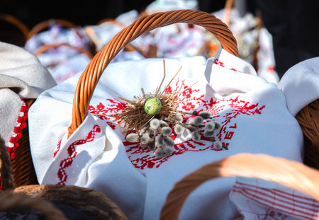 Traditional easter basket with embroidered cloth and decorative egg nest.の写真素材