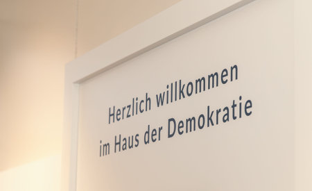 Welcome sign at haus der demokratie in berlin with german text on wall.の写真素材