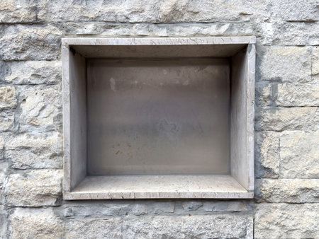 Stone niche in gray textured wall for architectural design or display.
